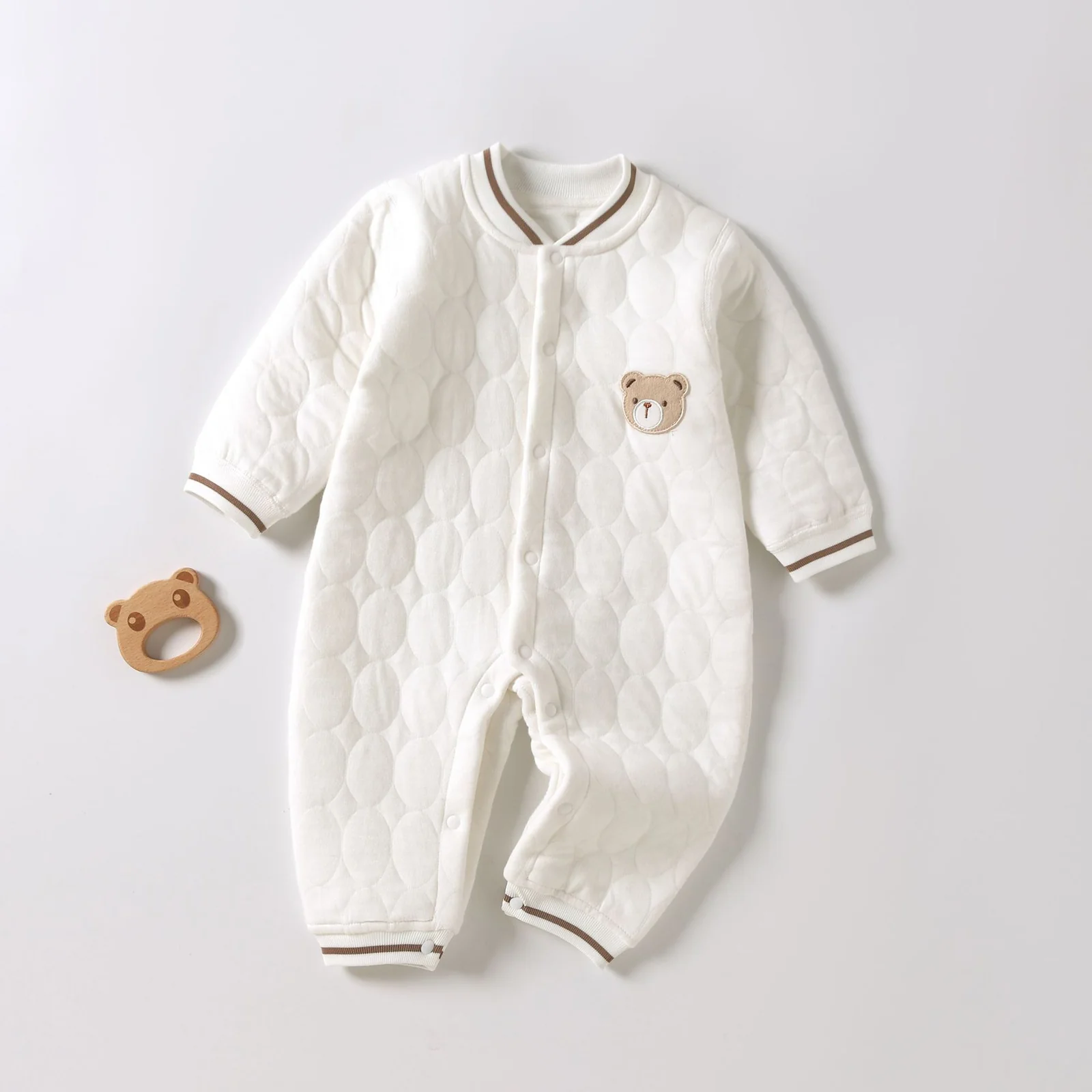 The winter one-piece garment for infants and toddlers is padded with cotton